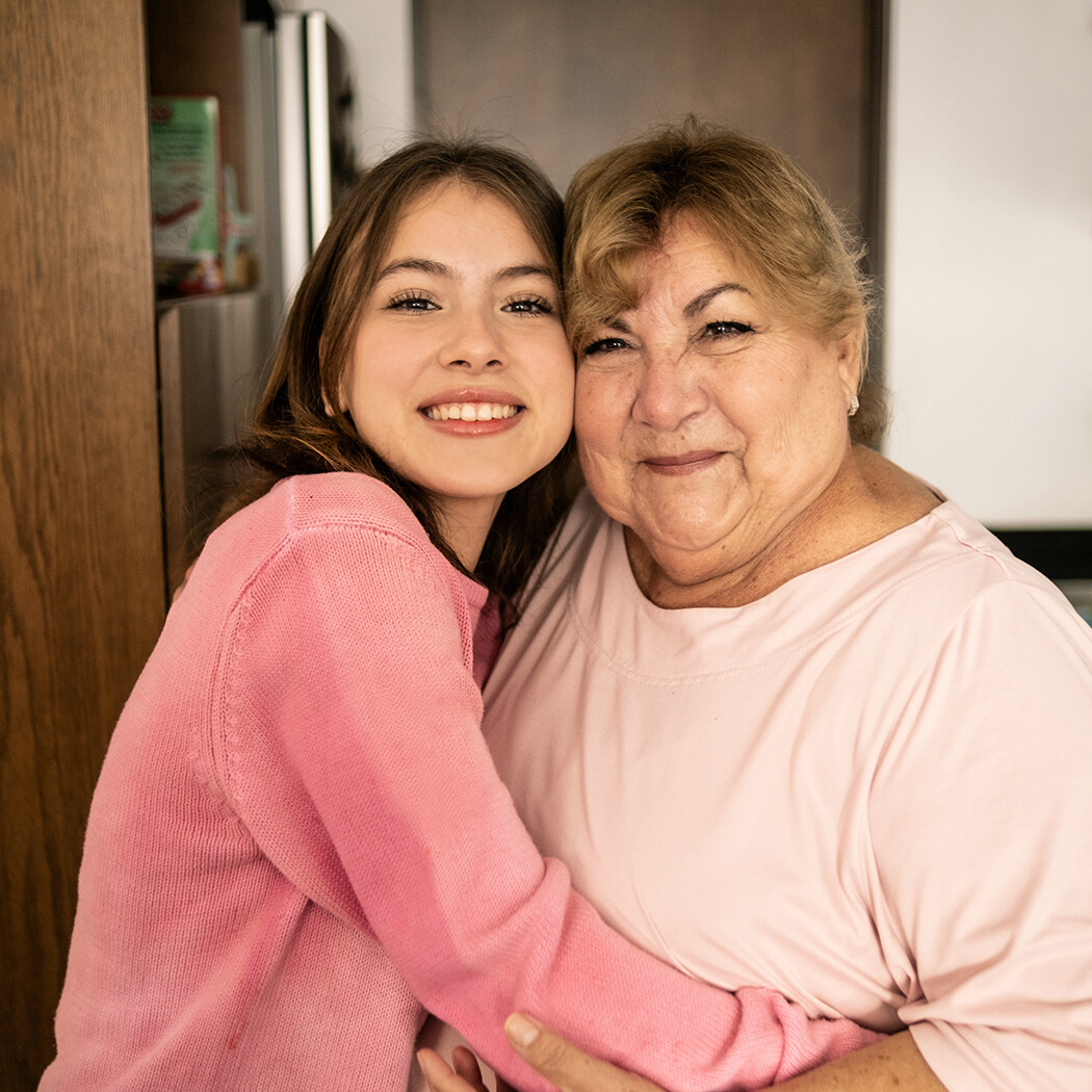 Girl smiling cheek to cheek with an older woman