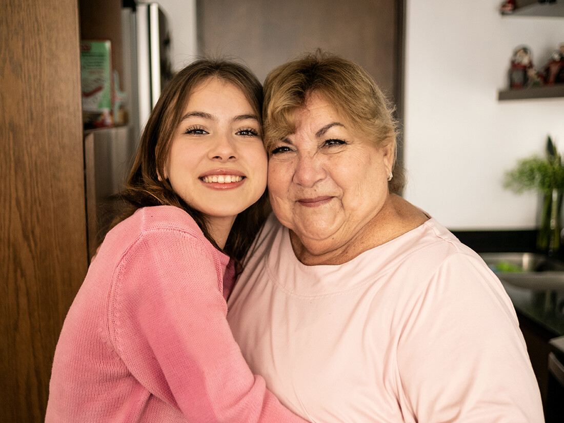 Girl smiling cheek to cheek with an older woman