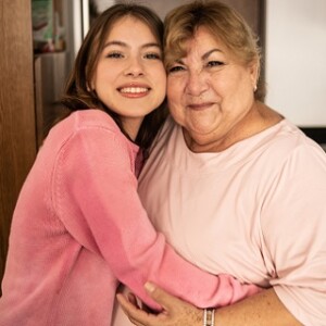 Portrait of a grandmother and granddaughter hugging.